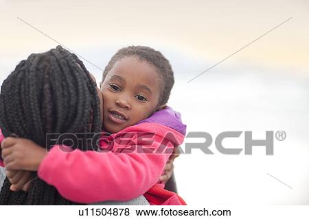 Woman hugging child View Large Photo Image Stock Photo - Woman hugging child. Fotosearch