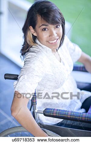Stock Image - Woman in wheelchair. Fotosearch