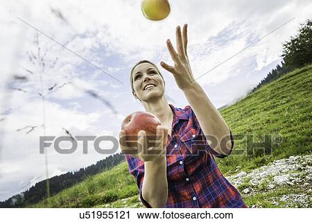 Stock Image - Woman juggling apples. Fotosearch