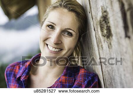 Woman leaning against exterior wall of wooden shack View Large Photo Image Stock Photo - Woman leaning against exterior wall of wooden shack. Fotosearch