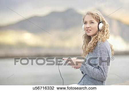 Woman listening to music, Hout Bay, Cape Town, South Africa View Large Photo Image Stock Image - Woman listening to music, Hout Bay, Cape Town, South Africa. Fotosearch