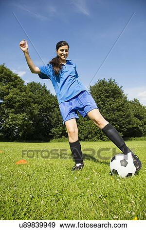 Stock Photo - Woman playing soccer. Fotosearch