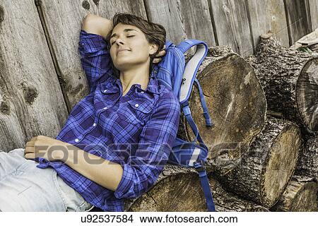 Woman sleeping on stack of cut logs View Large Photo Image Picture - Woman sleeping on stack of cut logs. Fotosearch