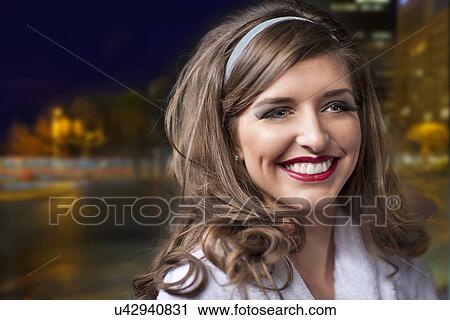 Stock Image - Woman wearing 1950s hairstyle and wide smile. Fotosearch