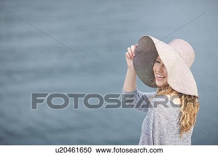 Woman wearing hat enjoying sea View Large Photo Image Stock Image - Woman wearing hat enjoying sea. Fotosearch