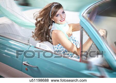 Woman with windblown hair driving vintage convertible View Large Photo Image Stock Photo - Woman with windblown hair driving vintage convertible. Fotosearch