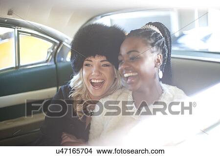 Picture - Women enjoying ride in vintage car. Fotosearch