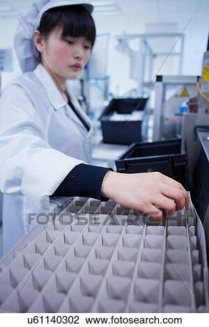 Worker at small parts manufacturing factory in China View Large Photo Image Stock Image - Worker at small parts manufacturing factory in China. Fotosearch