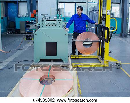 Worker at small parts manufacturing factory in China, operating machinery View Large Photo Image Stock Image - Worker at small parts manufacturing factory in China, operating machinery. Fotosearch
