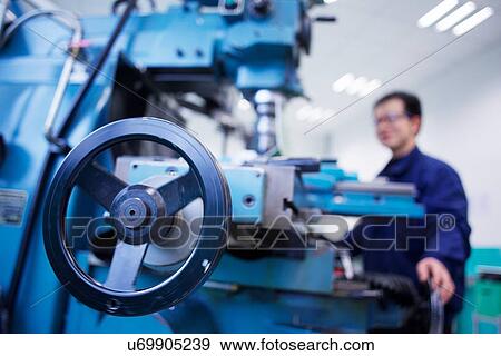 Worker at small parts manufacturing factory in China View Large Photo Image Stock Photo - Worker at small parts manufacturing factory in China. Fotosearch