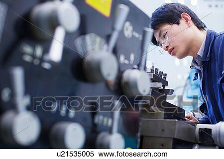 Worker at small parts manufacturing factory in China View Large Photo Image Stock Photography - Worker at small parts manufacturing factory in China. Fotosearch