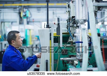 Worker at small parts manufacturing factory in China, pressing button on control panel View Large Photo Image Stock Photography - Worker at small parts manufacturing factory in China, pressing button on control panel. Fotosearch