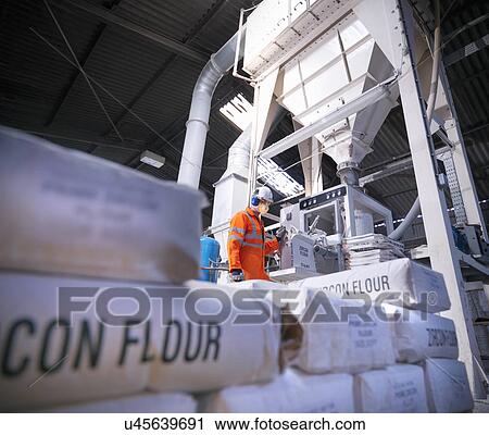 Worker in protective clothing filling zircon flour bags in mill, low angle view View Large Photo Image Stock Image - Worker in protective clothing filling zircon flour bags in mill, low angle view. Fotosearch