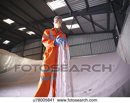 Worker in reflective clothing inspecting zircon sand View Large Photo Image Stock Image - Worker in reflective clothing inspecting zircon sand. Fotosearch