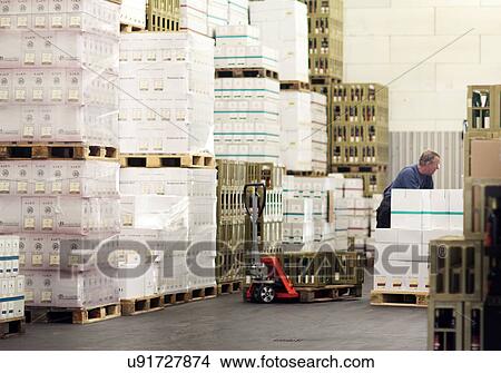 Picture - Worker moving packaged boxes of wine. Fotosearch