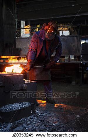 Worker pre forms steel billet on 5 tonne clear space hammer before it will be presented to set of two dies to be fully forged in hammer View Large Photo Image Stock Photography - Worker pre forms steel billet on 5 tonne clear space hammer before it will be presented to set of two dies to be fully forged in hammer. Fotosearch