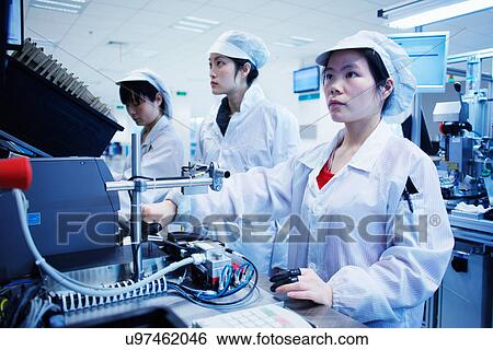 Stock Photograph - Workers at small parts manufacturing factory in China. Fotosearch