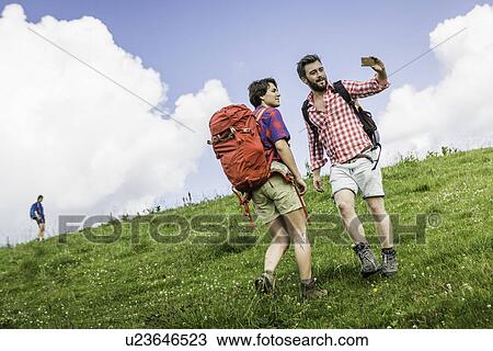 Young adults hiking, Tyrol, Austria View Large Photo Image Stock Image - Young adults hiking, Tyrol, Austria. Fotosearch