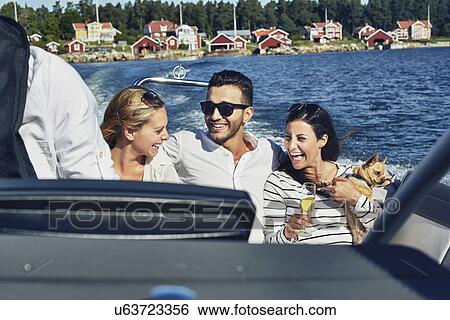 Stock Photograph - Young adults on boat, Gavle, Sweden. Fotosearch
