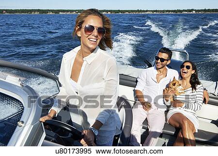 Stock Photography - Young adults on boat, Gavle, Sweden. Fotosearch