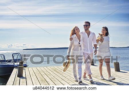 Young adults walking on pier, Gavle, Sweden View Large Photo Image Stock Image - Young adults walking on pier, Gavle, Sweden. Fotosearch