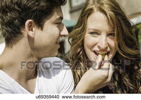 Young couple eating grapes View Large Photo Image Stock Image - Young couple eating grapes. Fotosearch