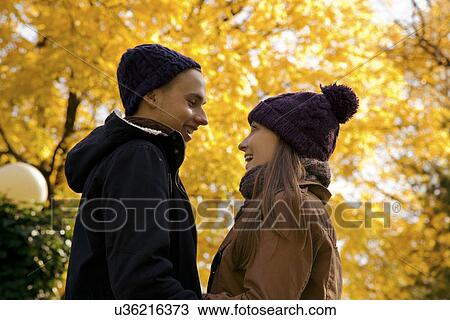 Young couple face to face in autumn park, Vienna, Austria View Large Photo Image Stock Image - Young couple face to face in autumn park, Vienna, Austria. Fotosearch