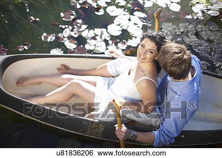 Young couple having fun in rowing boat View Large Photo Image Stock Photograph - Young couple having fun in rowing boat. Fotosearch