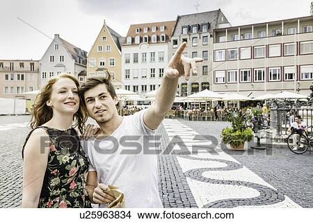 Picture - Young couple in town square in Augsburg, Bavaria, Germany. Fotosearch