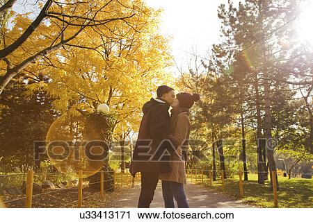 Young couple kissing in autumn park, Vienna, Austria View Large Photo Image Stock Image - Young couple kissing in autumn park, Vienna, Austria. Fotosearch