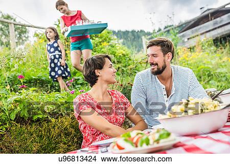 Young couple sharing picnic lunch, Tyrol, Austria View Large Photo Image Picture - Young couple sharing picnic lunch, Tyrol, Austria. Fotosearch