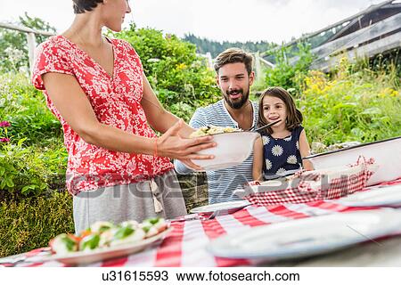 Young family sharing picnic lunch, Tyrol, Austria View Large Photo Image Stock Image - Young family sharing picnic lunch, Tyrol, Austria. Fotosearch