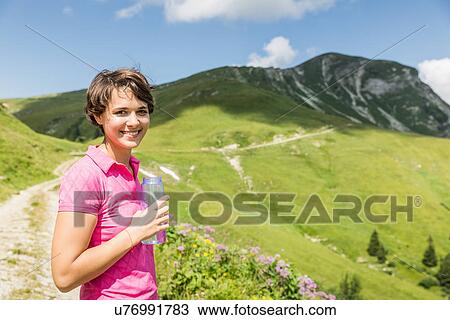 Young female hiker with bottled water, Tyrol, Austria View Large Photo Image Stock Image - Young female hiker with bottled water, Tyrol, Austria. Fotosearch