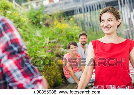 Young friends with waitress, Tyrol, Austria View Large Photo Image Stock Photo - Young friends with waitress, Tyrol, Austria. Fotosearch