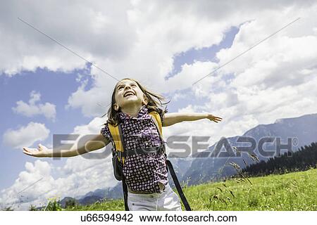 Young girl with arms out, Tyrol, Austria View Large Photo Image Stock Image - Young girl with arms out, Tyrol, Austria. Fotosearch