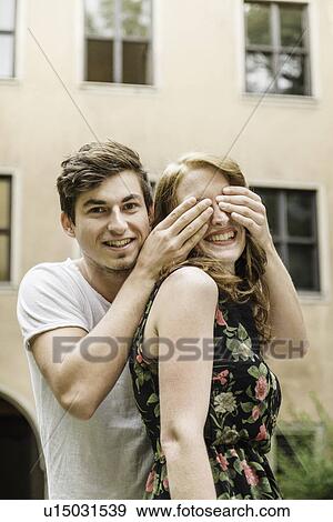 Young man covering girlfriend's eyes View Large Photo Image Stock Photo - Young man covering girlfriend's eyes. Fotosearch