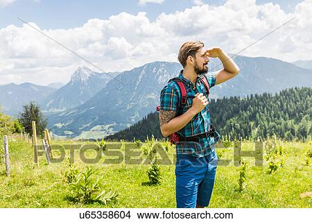 Young man hiking, Tyrol, Austria View Large Photo Image Picture - Young man hiking, Tyrol, Austria. Fotosearch