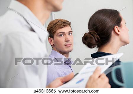 Stock Photography - Young man in business meeting. Fotosearch
