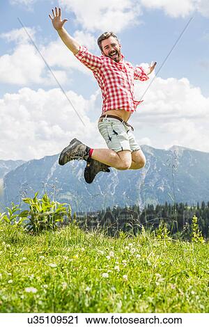 Young man leaping mid air, Tyrol, Austria View Large Photo Image Stock Image - Young man leaping mid air, Tyrol, Austria. Fotosearch
