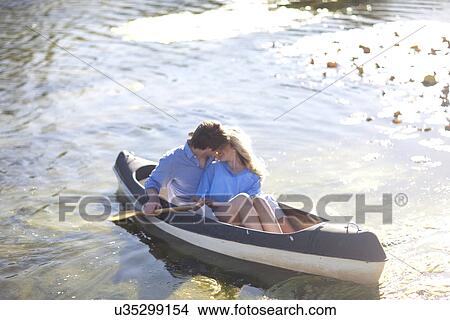 Picture - Young romantic couple in rowing boat on river. Fotosearch