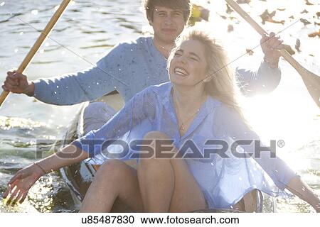 Young romantic couple splashing around in rowing boat View Large Photo Image Stock Image - Young romantic couple splashing around in rowing boat. Fotosearch
