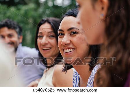 Young woman amongst family members View Large Photo Image Stock Photography - Young woman amongst family members. Fotosearch