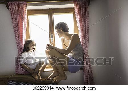 Picture - Young woman and daughter in holiday chalet, Tyrol, Austria. Fotosearch