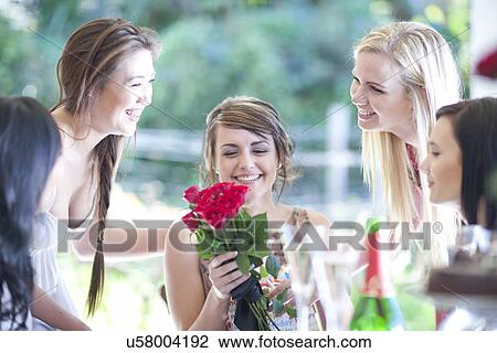 Young woman and friends with bunch of roses View Large Photo Image Stock Image - Young woman and friends with bunch of roses. Fotosearch