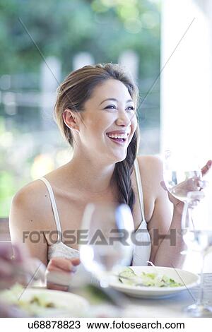 Young woman at the dinner table View Large Photo Image Stock Image - Young woman at the dinner table. Fotosearch