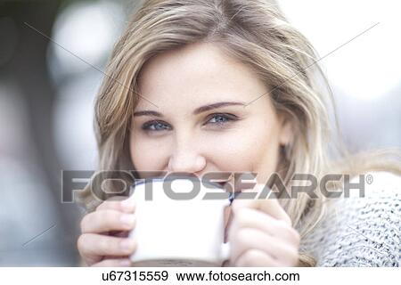 Stock Photo - Young woman drinking coffee. Fotosearch