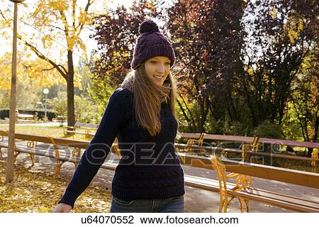 Young woman enjoying autumn in park View Large Photo Image Stock Image - Young woman enjoying autumn in park. Fotosearch