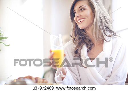 Young woman enjoying breakfast in bed View Large Photo Image Stock Photo - Young woman enjoying breakfast in bed. Fotosearch