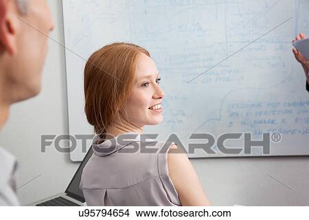 Young woman looking over shoulder View Large Photo Image Picture - Young woman looking over shoulder. Fotosearch