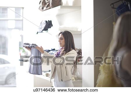 Young woman shopping View Large Photo Image Stock Photograph - Young woman shopping. Fotosearch